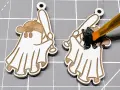 Painting a laser-engraved ghost with a baseball bat black. This shows how to color laser engraving for a spooky effect.