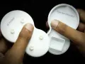 Hands hold two white plastic parts, one labeled "3D Printed" and the other "Injection Moulded," showcasing the difference between the two manufacturing methods.