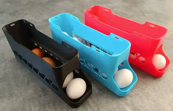 3D printed egg holders in black, blue, and red. See what you can do with a 3d printer: create practical kitchen organizers!